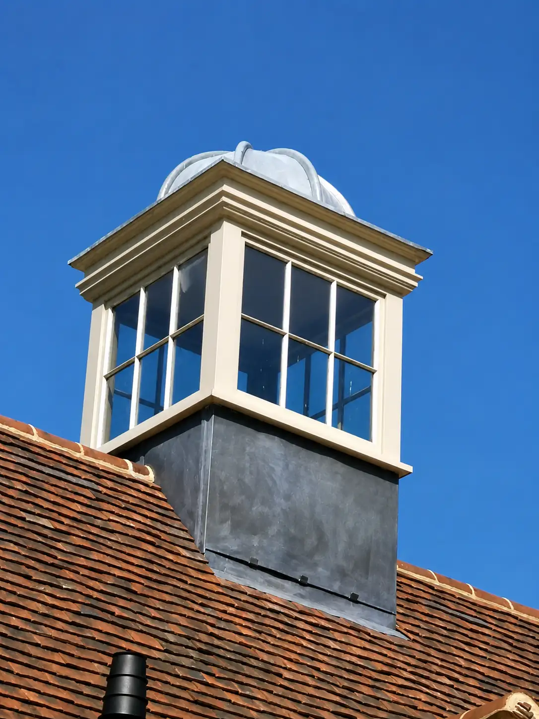 Bespoke painted roof lantern with leaded glazing and a lead-clad base on a tiled Sussex roof
