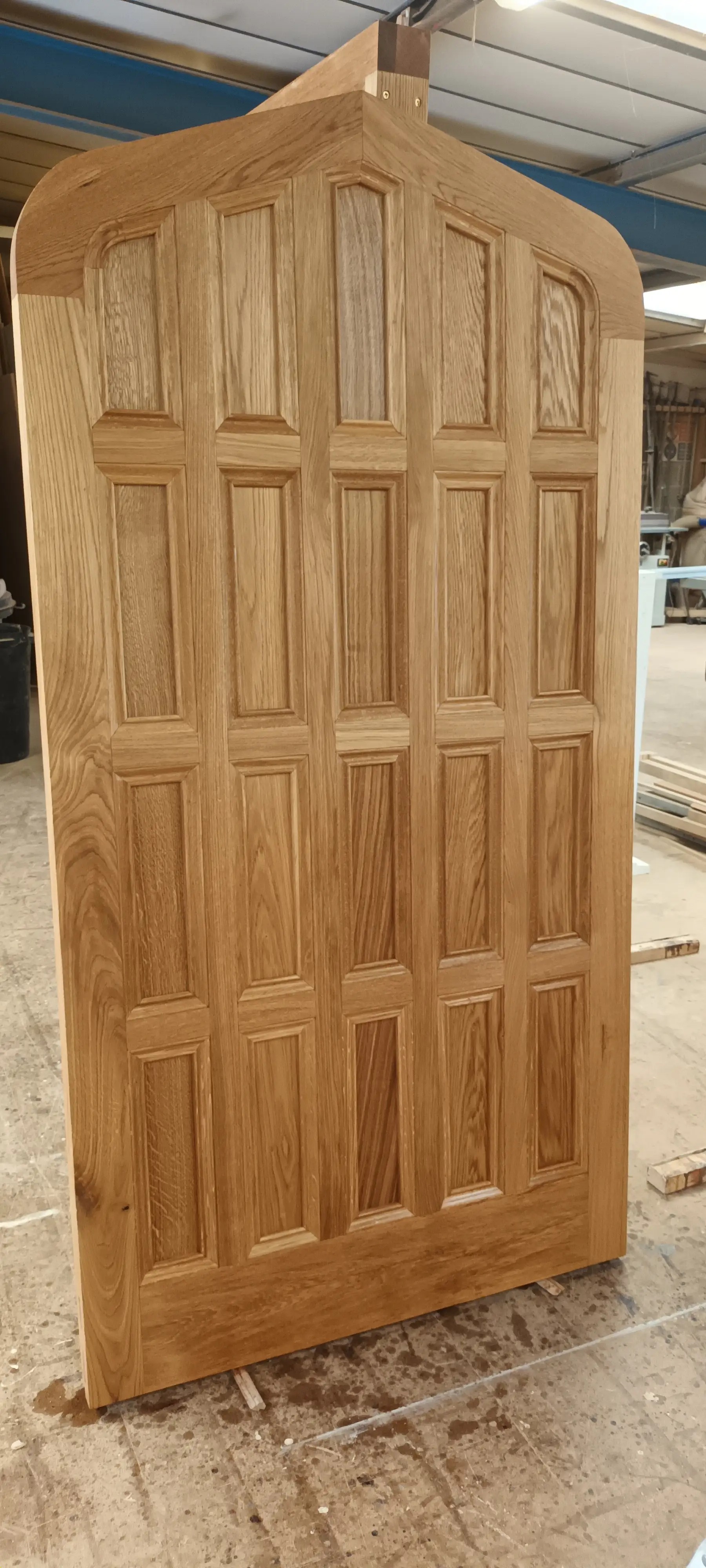 Large bespoke reproduction wooden door before installation in the workshop
