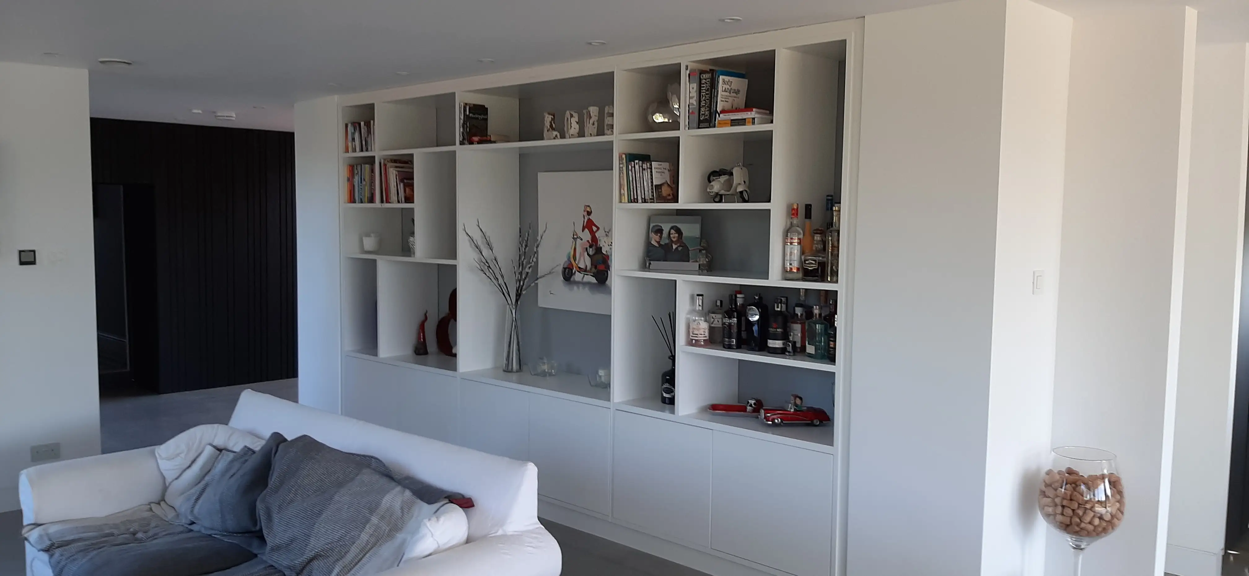 Bespoke fitted shelving and cabinets in a Sussex living room