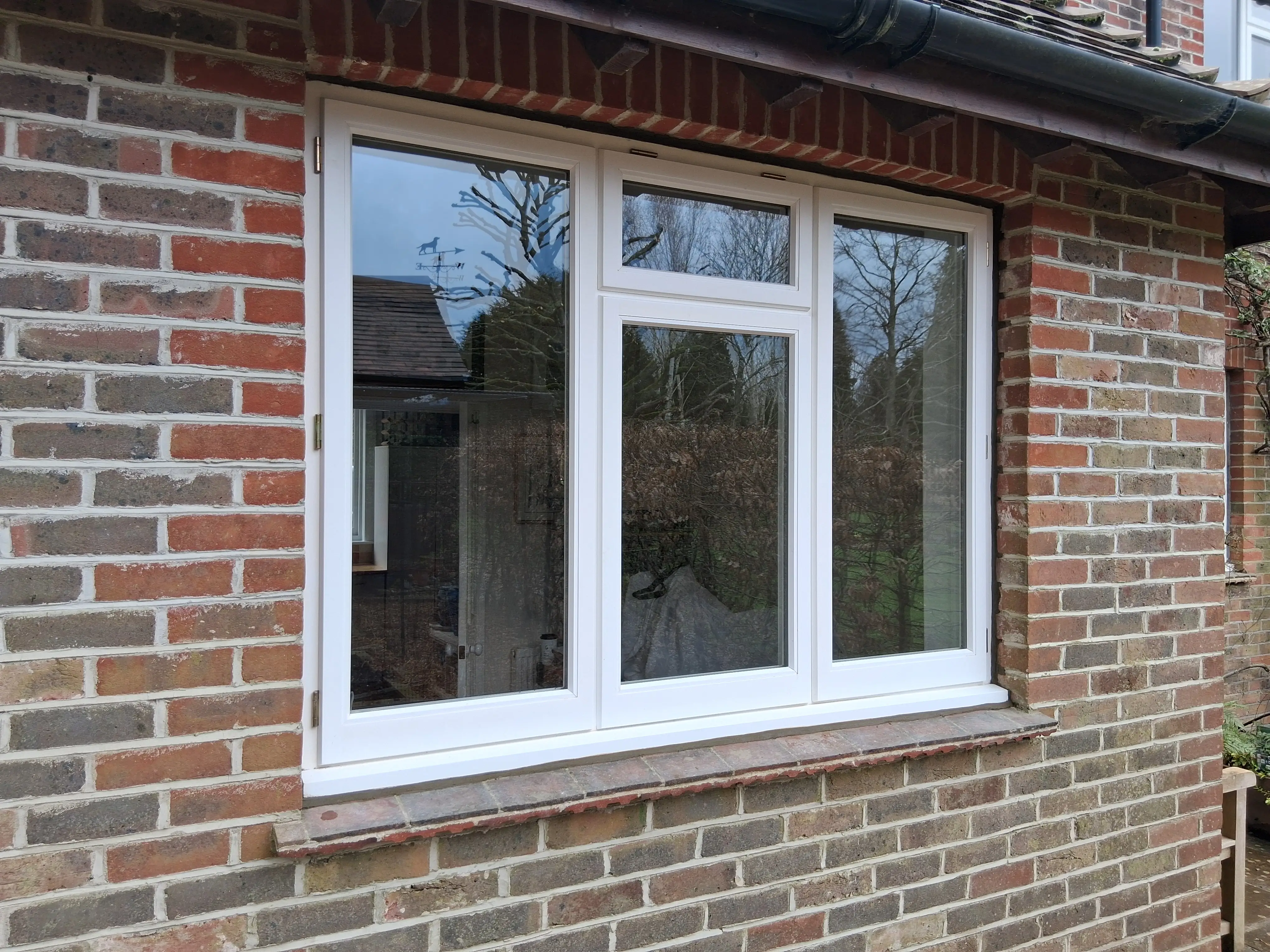 Detail of a hand-made timber casement window on a red-brick property
