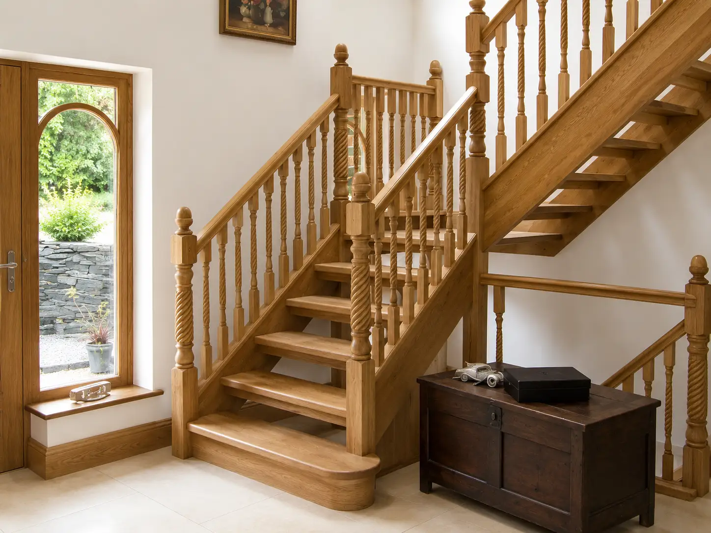 Traditional oak staircase with turned barley-twist spindles, shaped newel posts and a half-landing