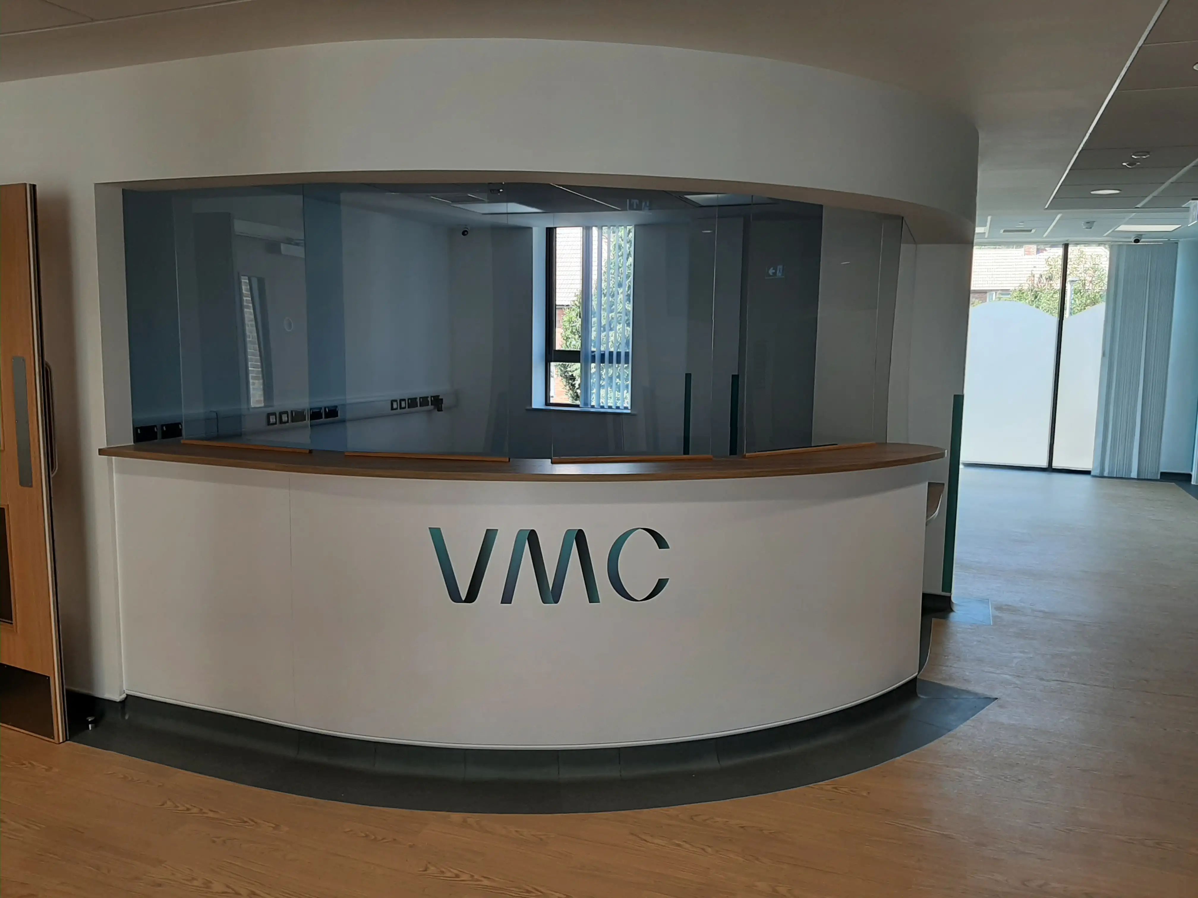 Bespoke curved white reception desk with oak top
