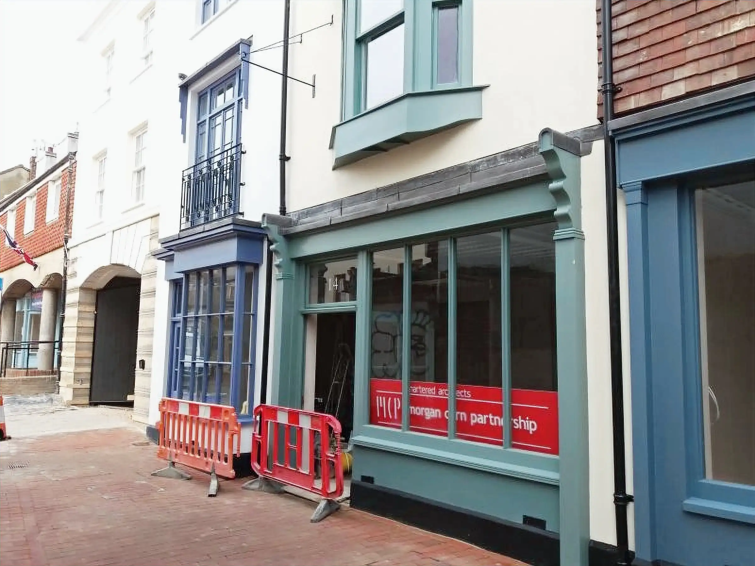 Sage green hand-built shopfront on a Sussex high street