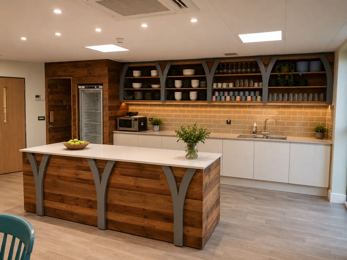 Bespoke reclaimed-timber tea-point island and shelving with steel brackets in a commercial fit-out